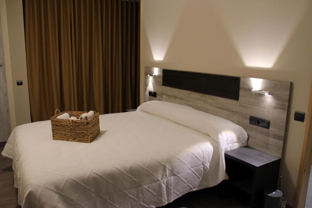 a hotel room with a bed with a basket on it at Ca L´Ángels in Prat de Compte