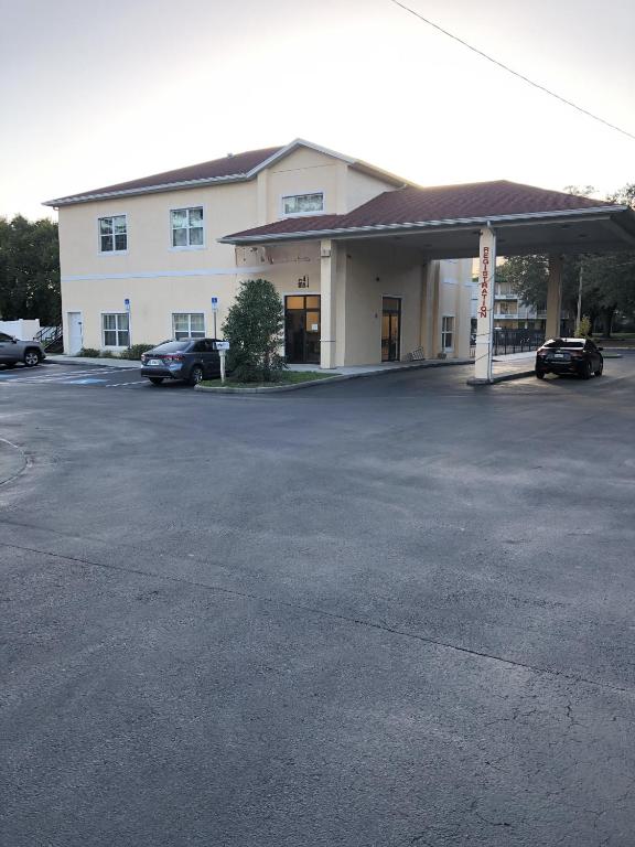 a parking lot in front of a building at Green Palms Extended Stay in Kissimmee