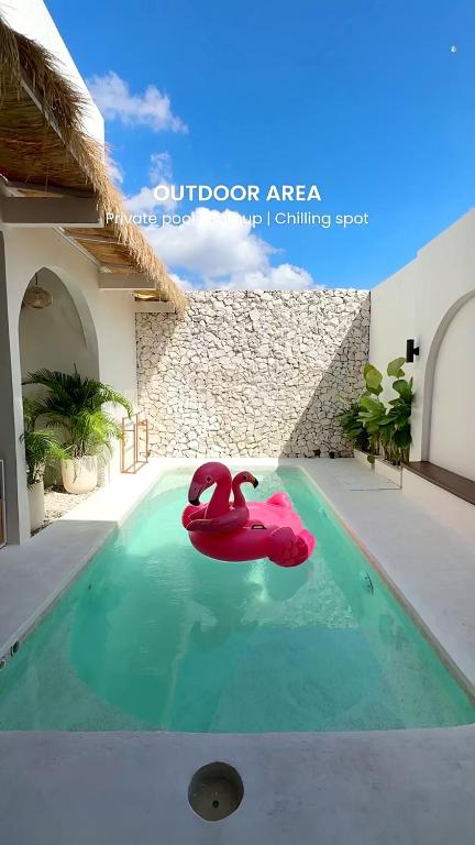 a red float in a swimming pool in a house at Semasa Jogja Villa in Adi Sutjipto