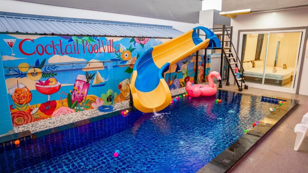 a swimming pool with a water slide in a play room at Cocktail Poolvilla Pattaya in Na Jomtien