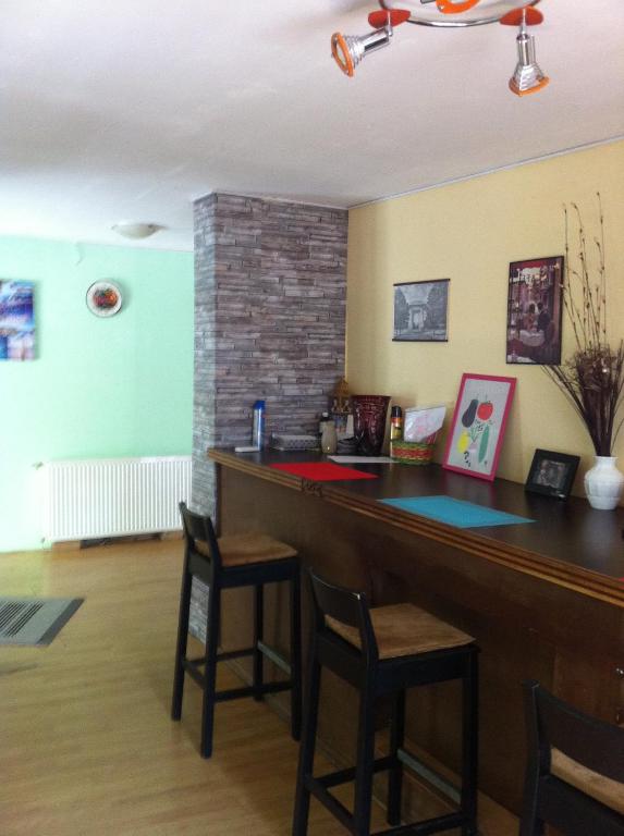 a bar in a room with chairs and a brick wall at Old Centrum Bucharest in Bucharest