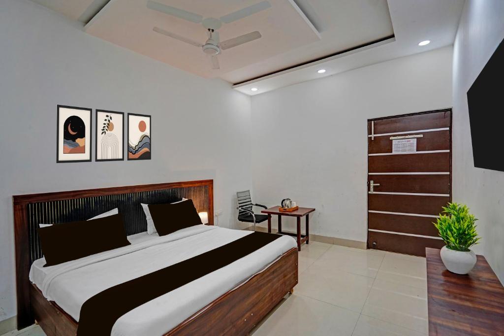 a bedroom with a large bed and a dresser at Hotel O Sector 110 Noida Formerly Luv Kush Tower Bhangel in Noida