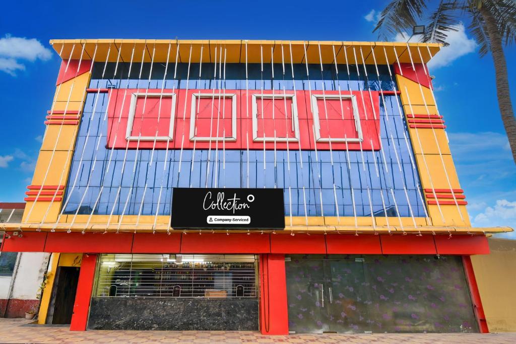 a building with red windows and a sign on it at Collection O Dattapukur Railway Terminal Kolkata in Bārāsat