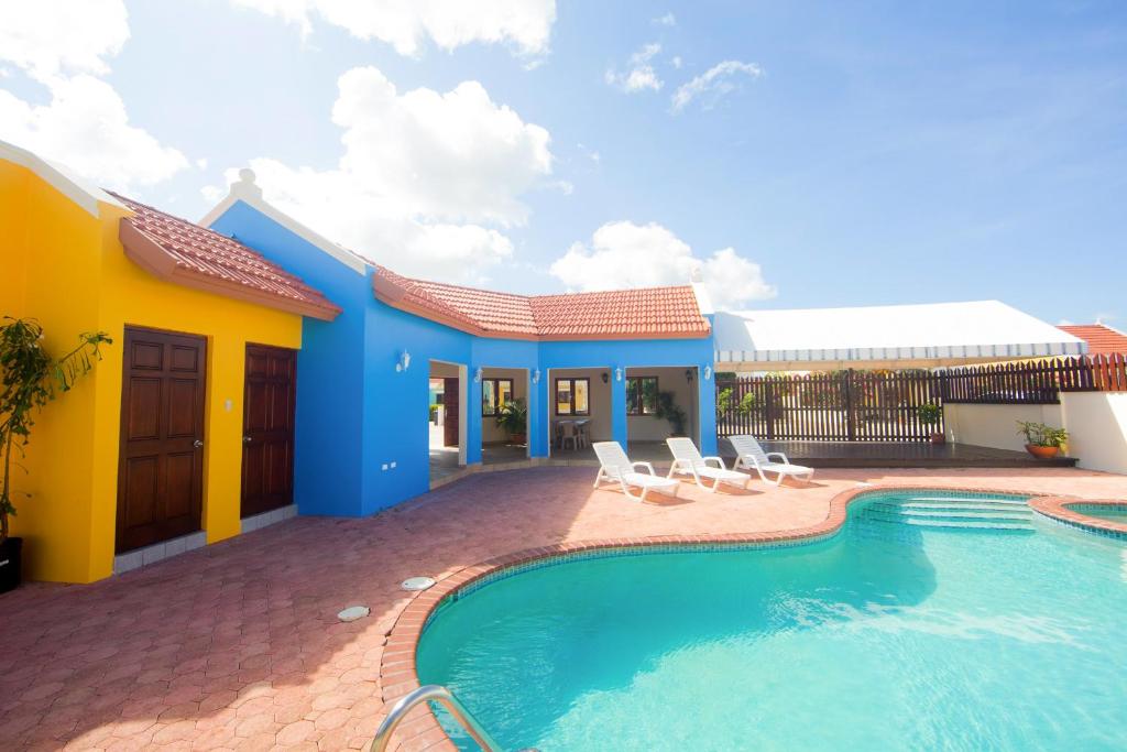a house with a swimming pool in front of it at Cunucu Villa with Private Jacuzzi in Soledad