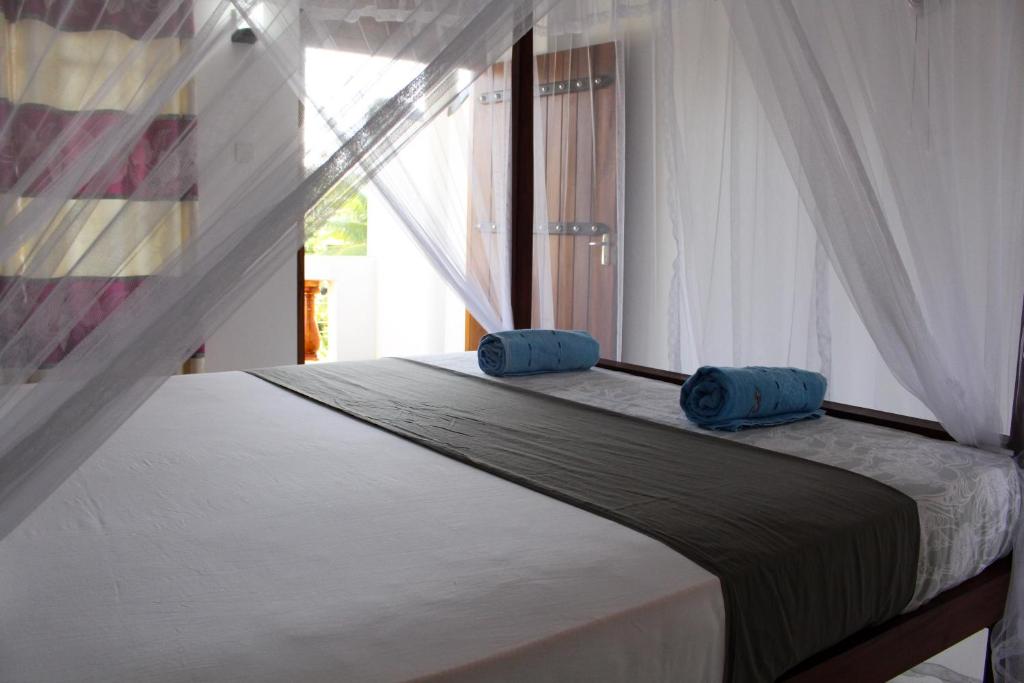 Postel nebo postele na pokoji v ubytování Orchid Rest