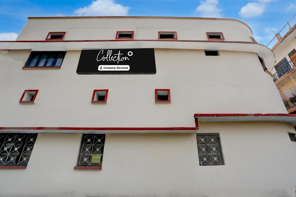 a white building with a black sign on it at Collection O Civil Lines Prayagraj in Prayagraj
