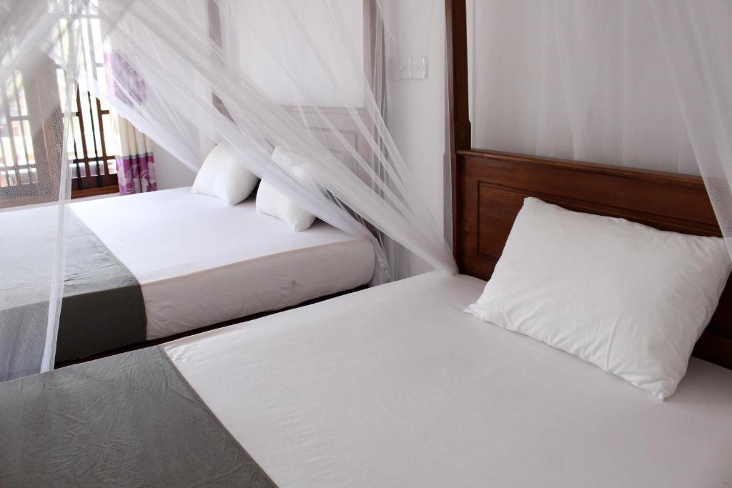 Postel nebo postele na pokoji v ubytování Orchid Rest