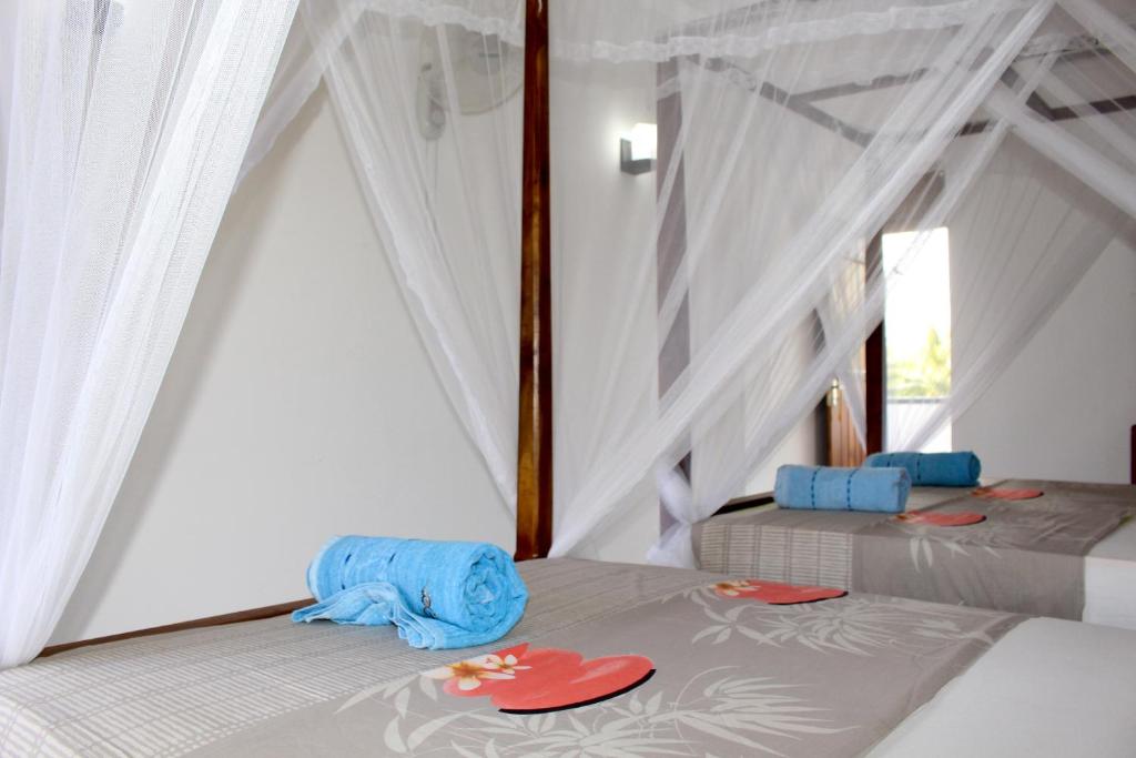 Postel nebo postele na pokoji v ubytování Orchid Rest