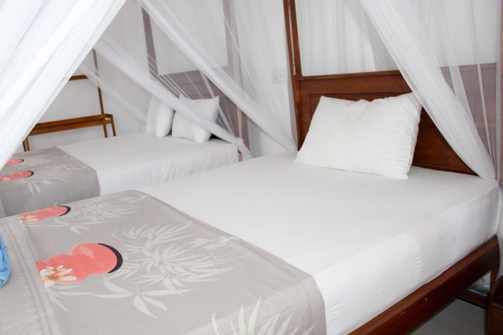 Postel nebo postele na pokoji v ubytování Orchid Rest