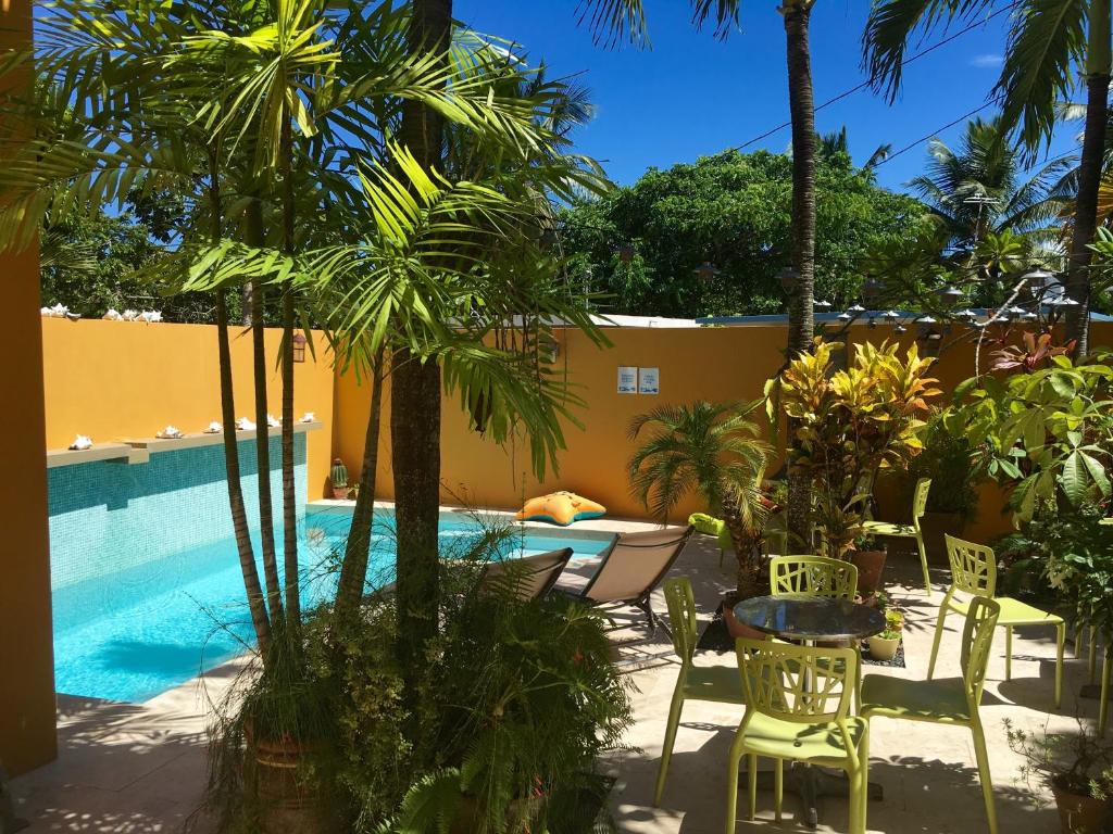 a patio with a table and chairs next to a pool at Casa de Amistad Guesthouse in Vieques