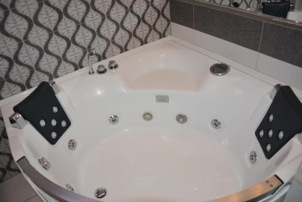 a white bath tub in a room at 24home in Dnipro