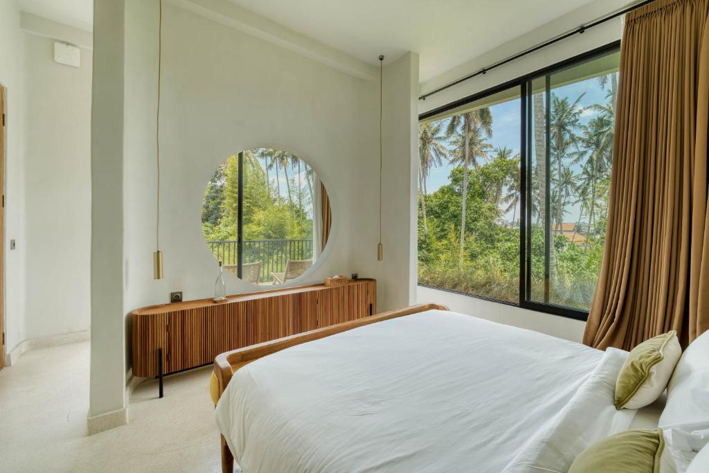 En eller flere senge i et værelse på Casa Blanca Villa