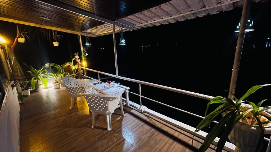 a balcony with a table and chairs on a ship at Palm Breeze in Udupi