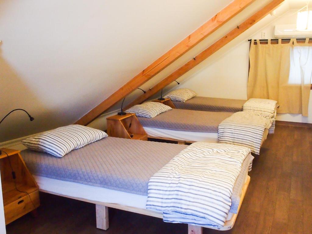 
A bed or beds in a room at Mua Guesthouse
