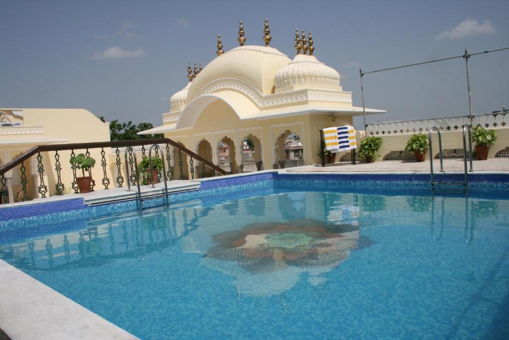 a large swimming pool in front of a mosque at Khandela Haveli - a Boutique Heritage Hotel in Jaipur