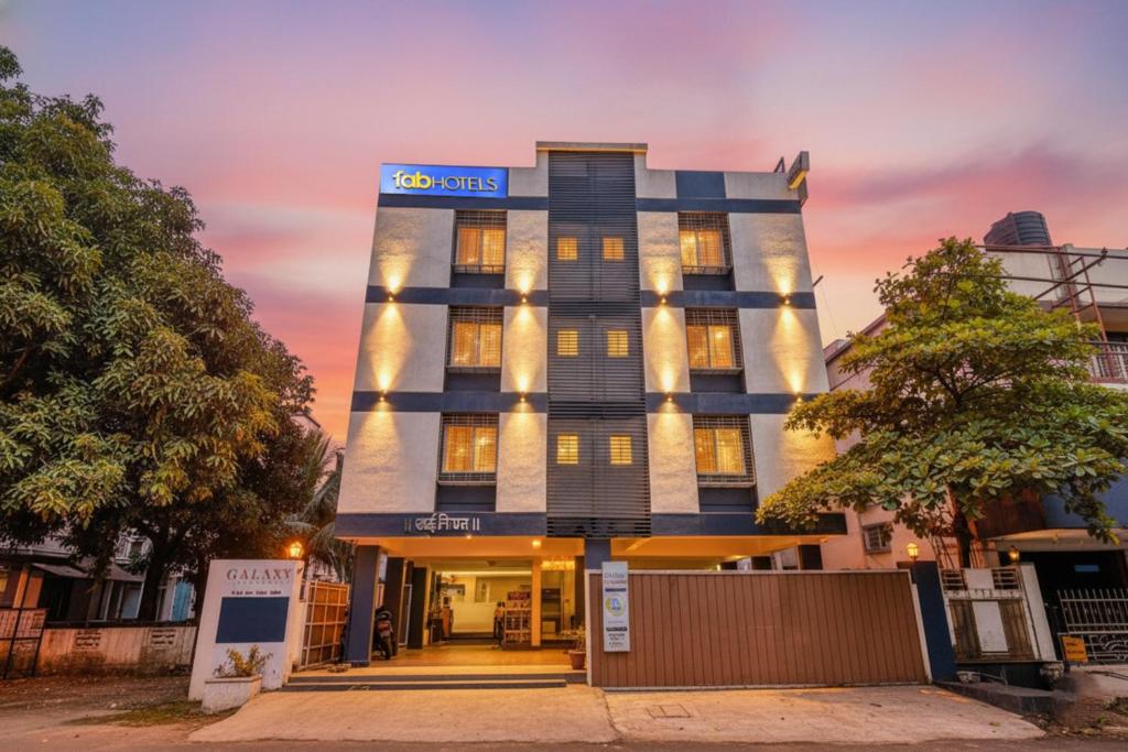 Una representación del hotel SBS al anochecer. en Via Galaxy Apartments - Lohegaon chowk, en Pune