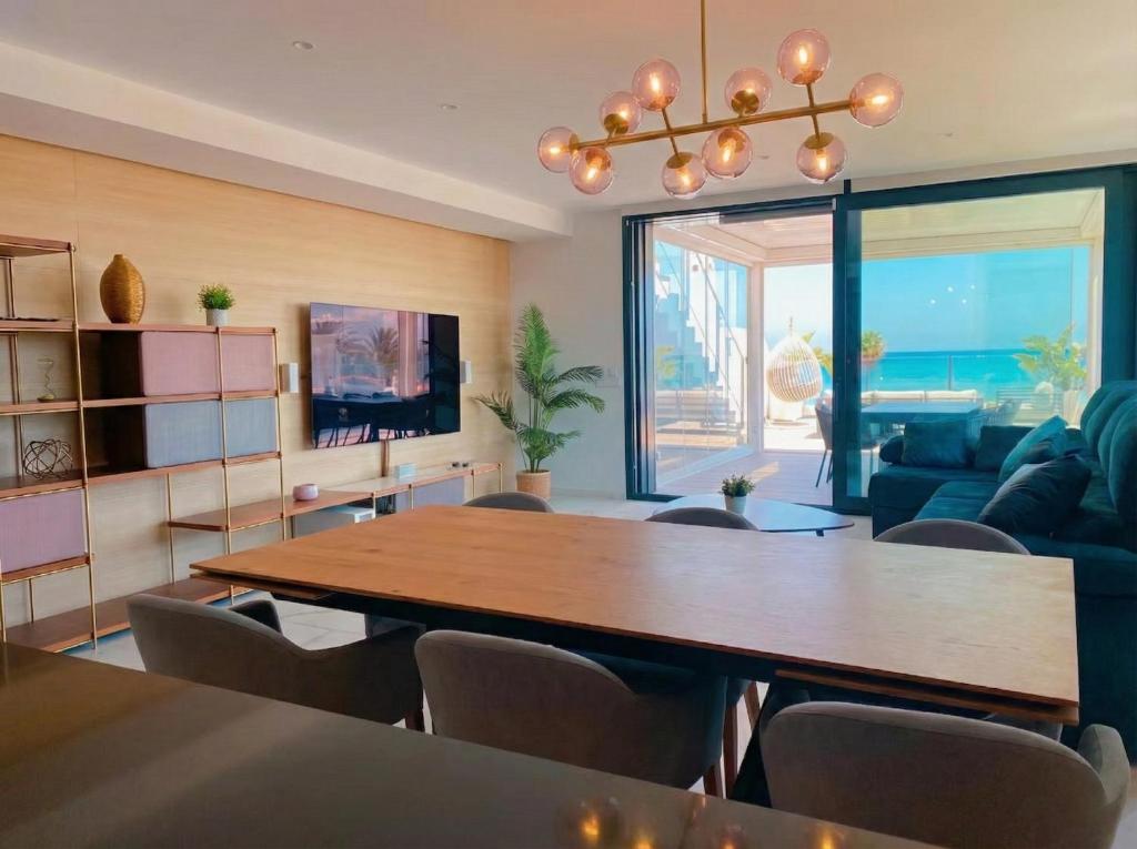 a living room with a table and a couch at holaVivienda - Ático Boutique de Lujo en la Playa in Denia
