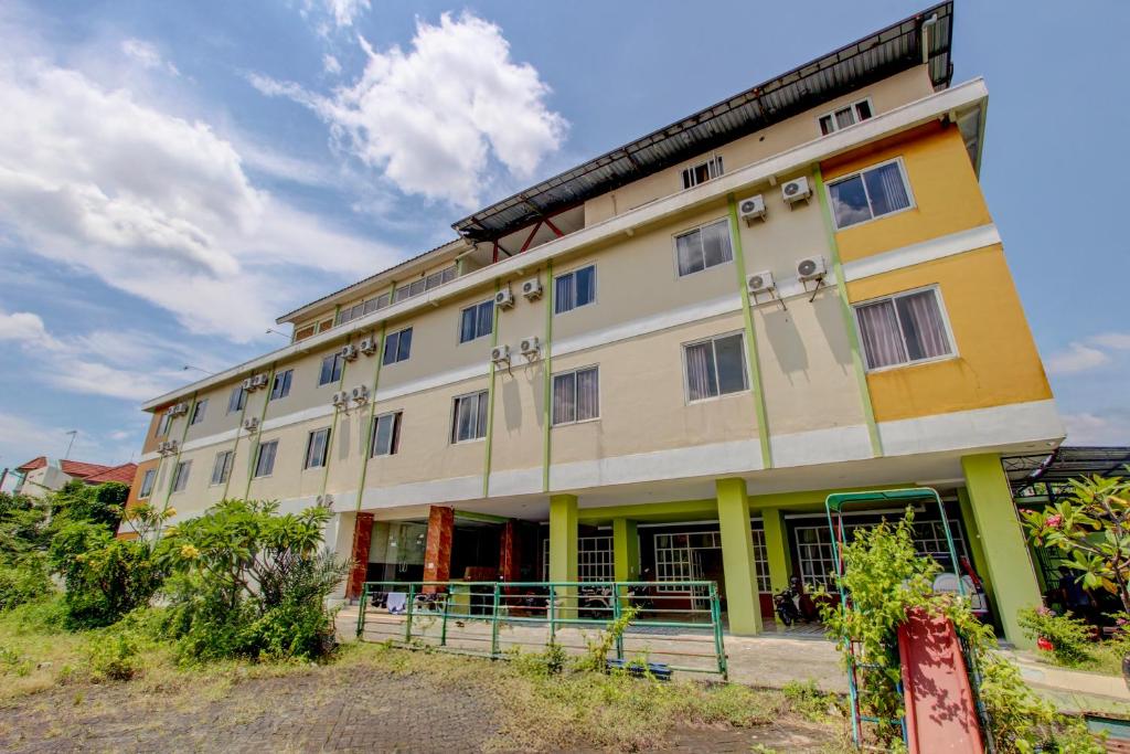 a large building with a lot of windows at Collection O near Stadion Manahan formerly Graha Laweyan Solo in Bonorejo