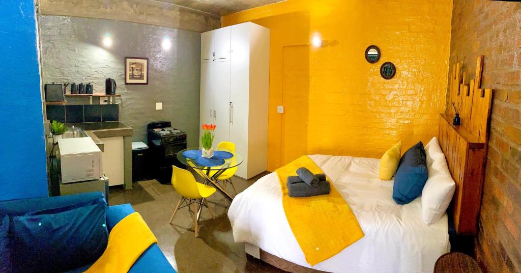 a bedroom with a large bed with a yellow wall at Craftsmanship 340 IMD in Johannesburg