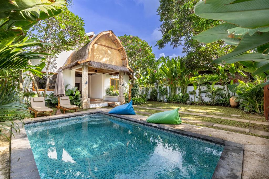 a villa with a swimming pool and a gazebo at Villa Trembesi - New Spacious Luxury 2BR Private Villa - Free Gym Access - 60Mbps WiFi in Kuta Lombok