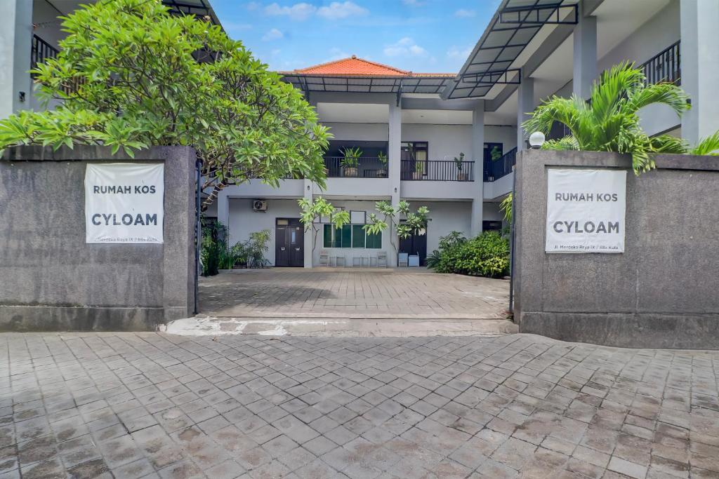 a building with two signs that say guzman at Hotel O near Trans Studio Theme Park formerly Cyloam Residence in Legian