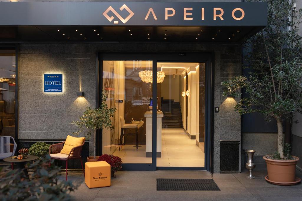 a entrance to a restaurant with a sign on the door at Apeiro City Avant-garde Hotel in Sarajevo