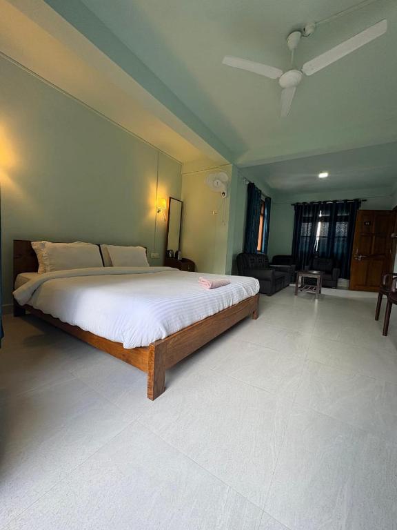 a bedroom with a large bed in a room at Riwai Root Bridge homestay in Mawlynnong