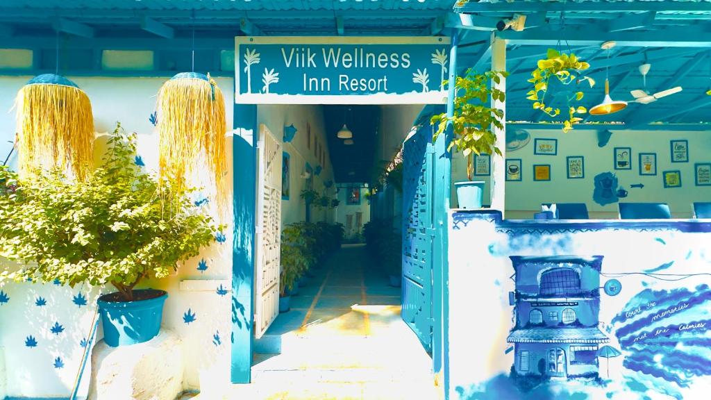 a blue and white building with a sign that reads villas inn resort at Viik wellness inn -3 Star Resort in Arambol Beach in Arambol