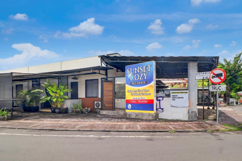 a gas station with a sign in front of it at Hotel O near Trans Studio Theme Park formerly Sunset Cozy Residence in Mantaak