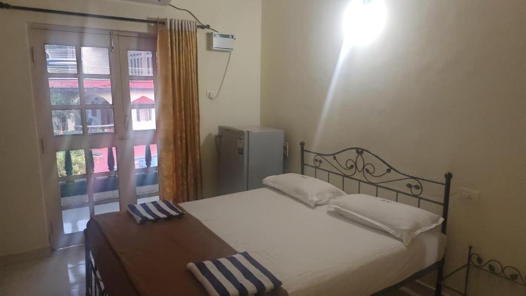 En eller flere senge i et værelse på Palm view inn