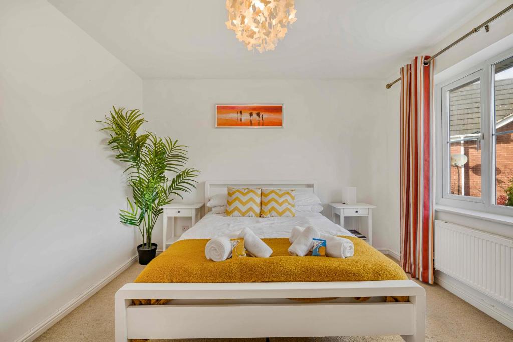 a bedroom with a bed with towels on it at Spacious 4 Bedroom Warrington House with Free Parking Perfect for Contractors, Families and Business Guests in Great Sankey