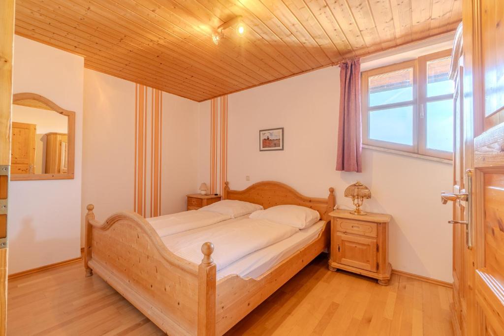 a bedroom with a wooden bed and a window at Lohberg Apartment in Lohberg