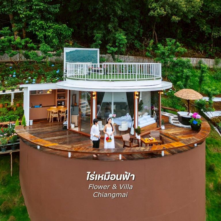 two people standing on top of a house at Rai hemuxnfa Villa in Mae Rim