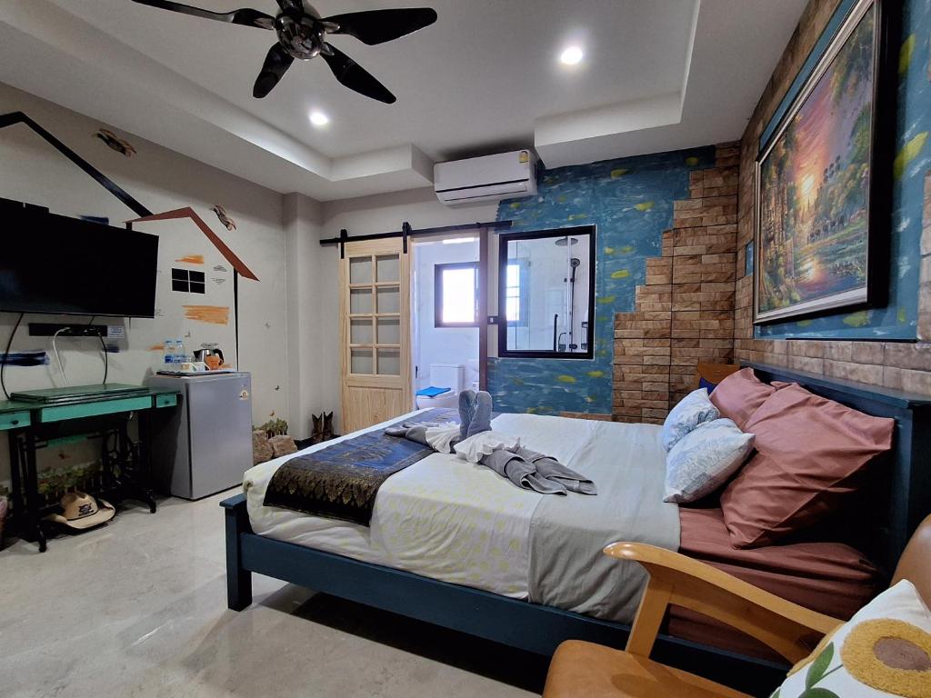 a bedroom with a bed and a ceiling fan at Turtle Nest in Hua Hin