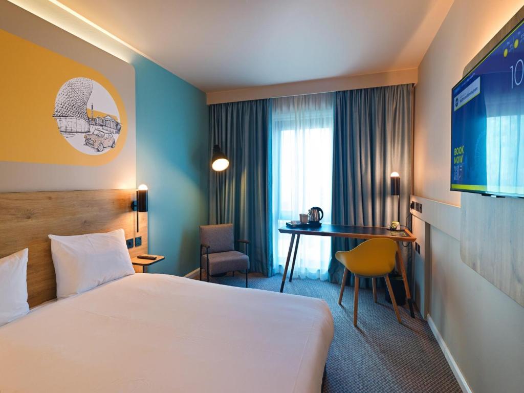 a hotel room with a bed and a desk at B&B HOTEL Birmingham Centre in Birmingham
