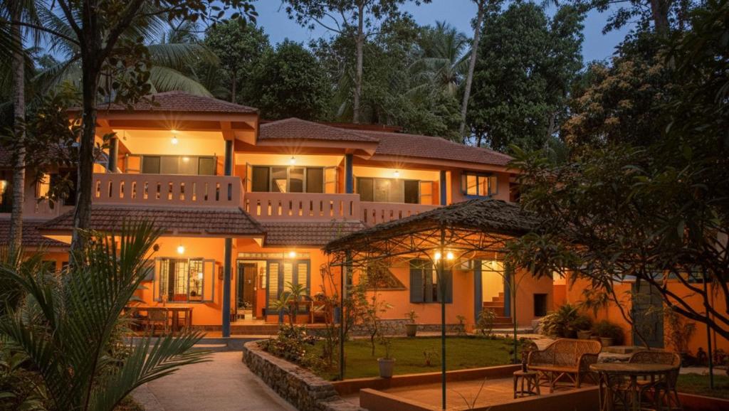 a large house with lights on in the night at NeelaHouse in Kovalam
