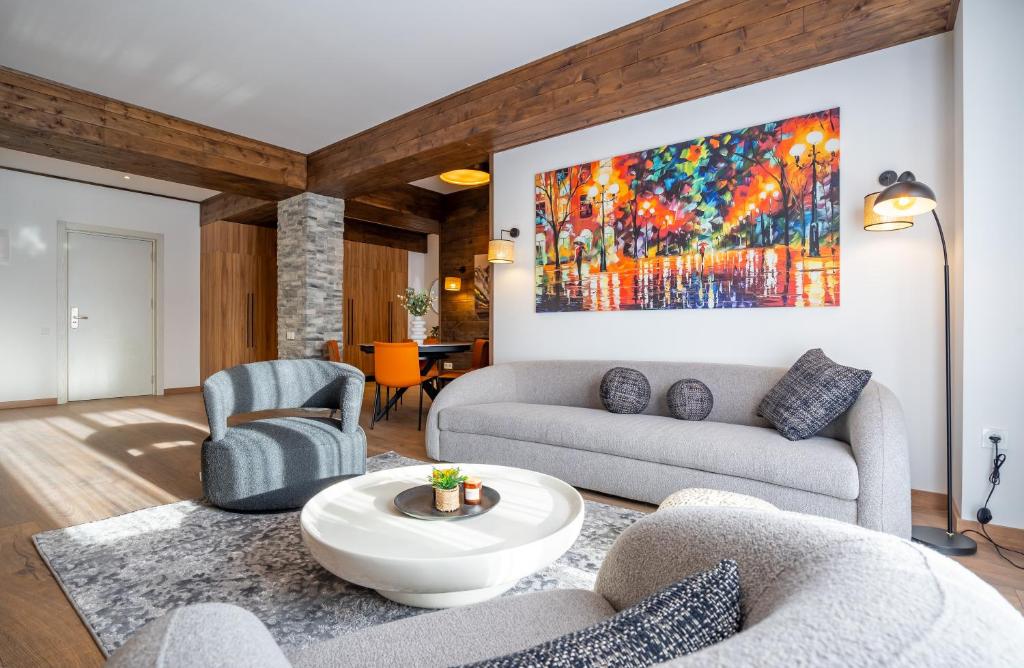 a living room with two couches and a table at NEO Skyview Suites in Gudauri