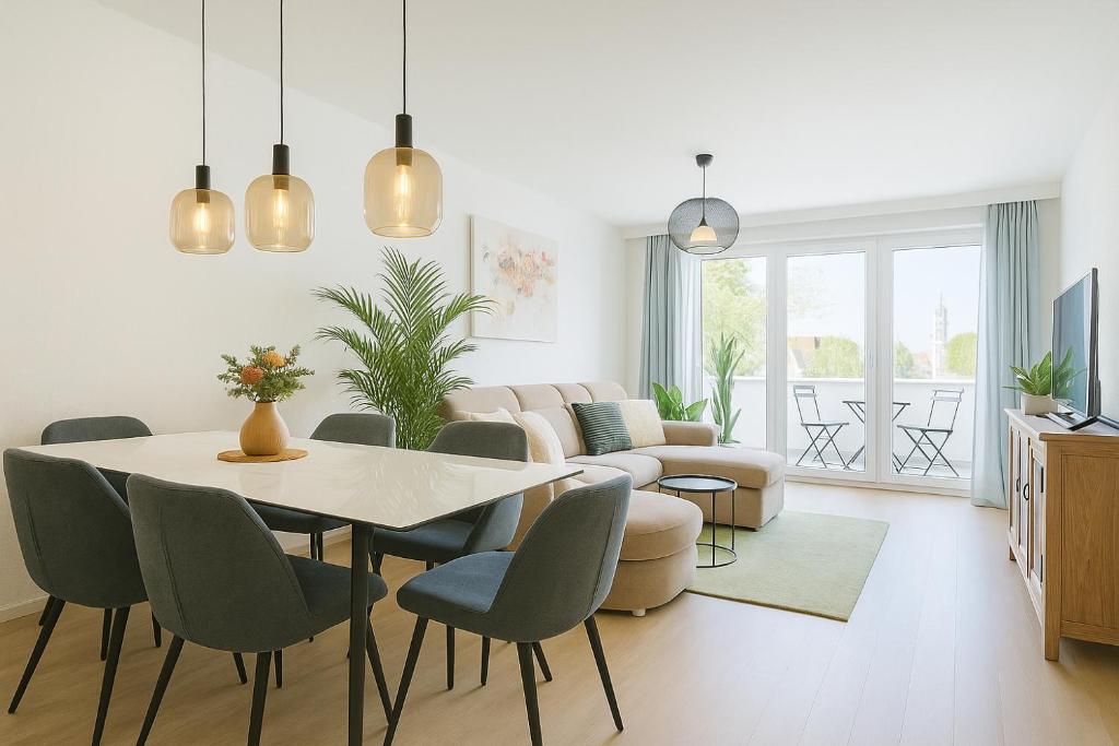 a living room with a dining room table and chairs at Altstadt Apt near Cathedral - free parking from January in Augsburg