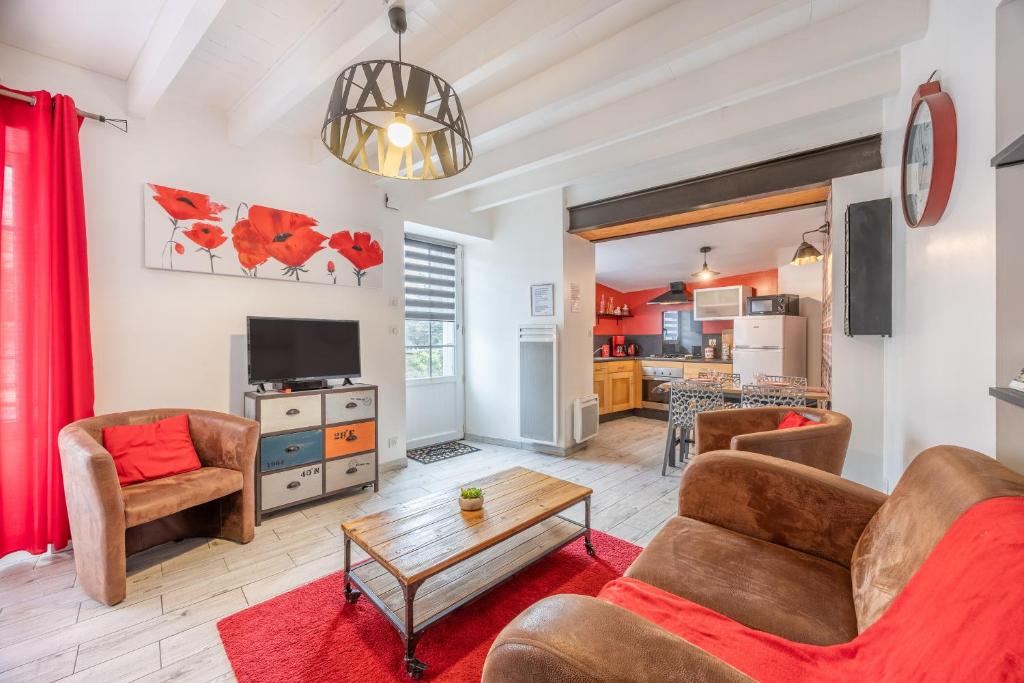 a living room with a couch and a table at Le Clemenceau in Les Épesses