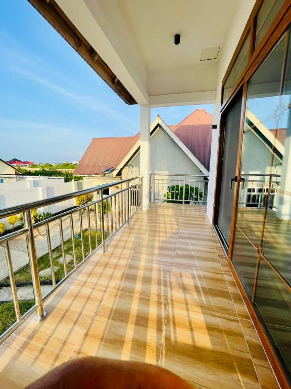a balcony with a view of a house at Leo Home in Nungwi