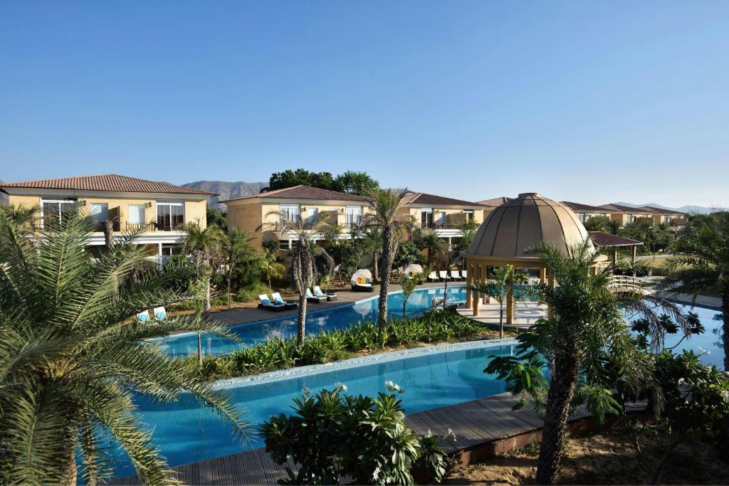 The Westin Pushkar Resort & Spa في بوشكار: صورة جوية لمنتجع به مسبح وقبة
