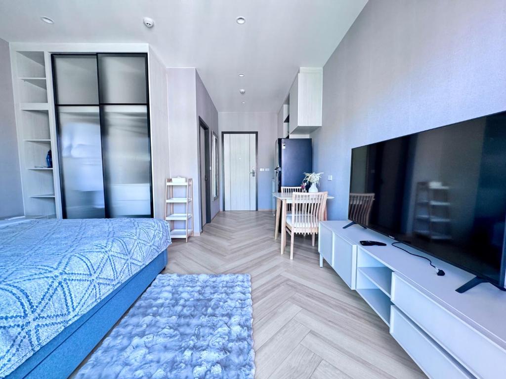 a bedroom with a bed and a flat screen tv at Title Legendary 7 floor Mountain View in Bang Tao Beach