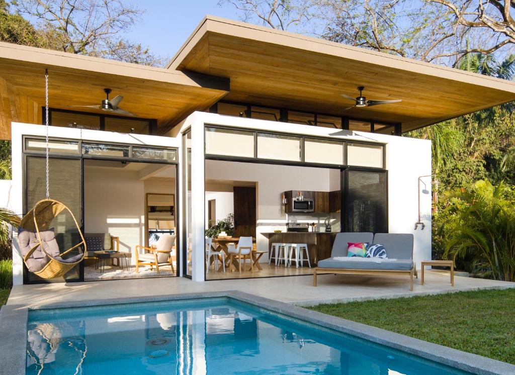 a house with a pool in front of it at Nalu Nosara Pool Villa Jardin in Nosara