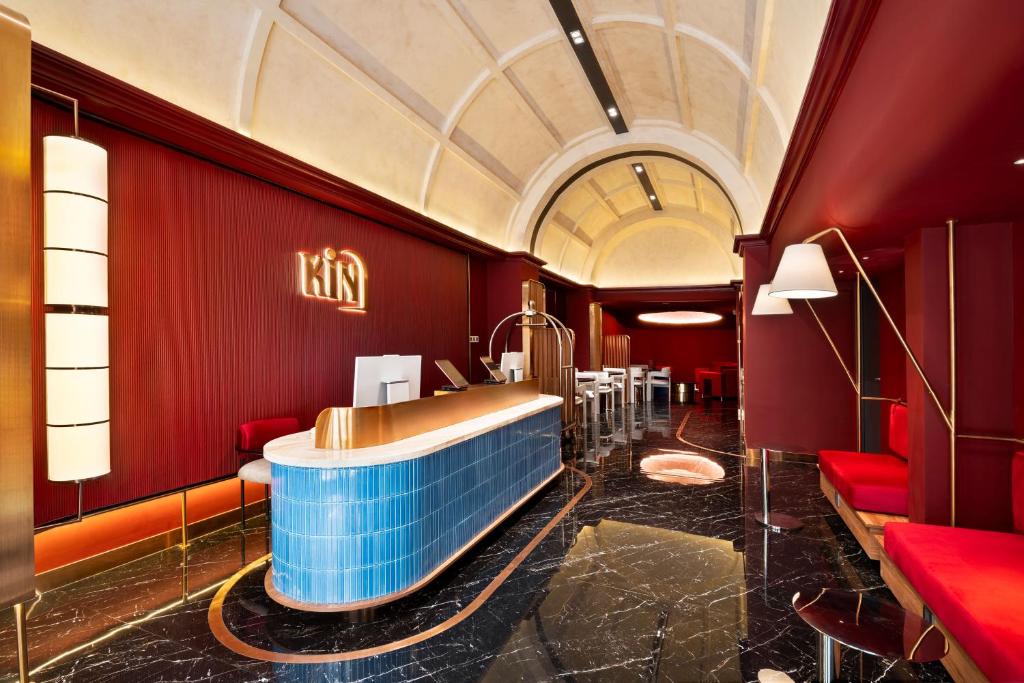 a salon with a tub in a room with red walls at KiN Hotel Onsen in Ho Chi Minh City