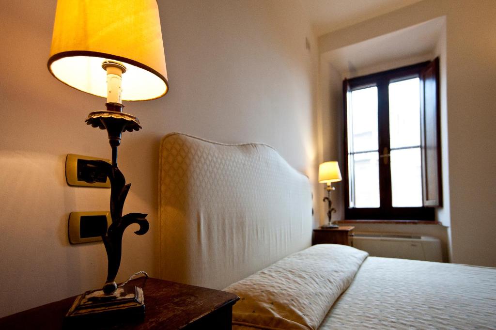 Łóżko lub łóżka w pokoju w obiekcie Hotel Scilla