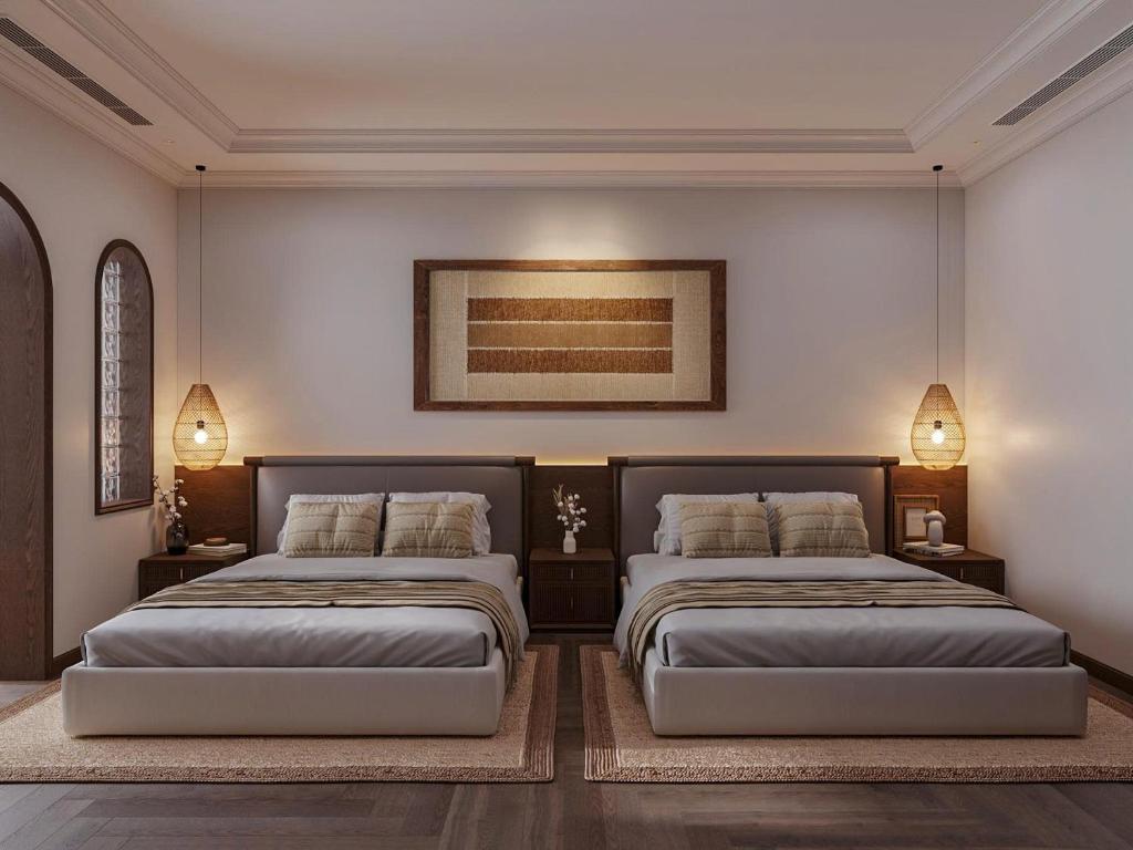 Un dormitorio con dos camas y un cuadro en la pared. en Home en Lagom, en Hanói