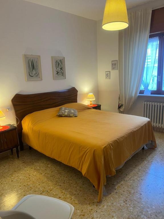 a bedroom with a large bed with a yellow bedspread at B&b Cristina - Appartamento Monte Coccia in Campo di Giove
