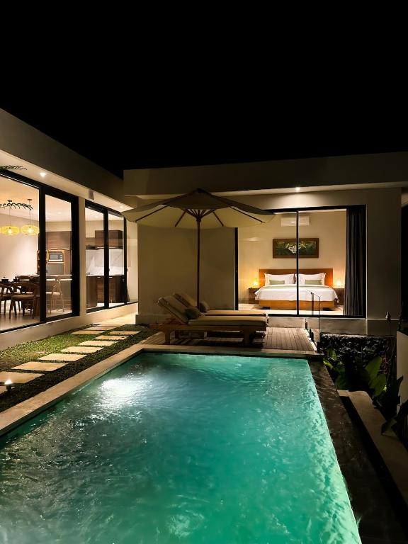 a swimming pool in a house with a bedroom at 3BR Nava villa Ubud in Ubud