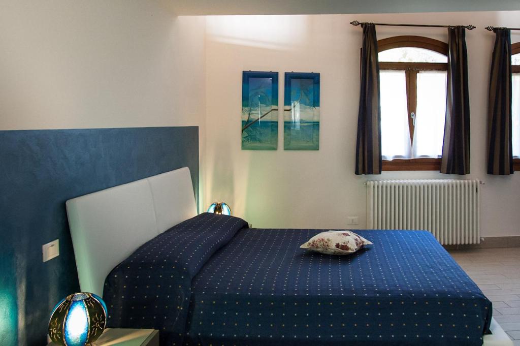 Postel nebo postele na pokoji v ubytování Appartamenti Antico Frantoio Doria