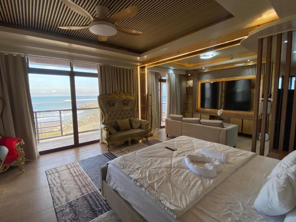 a bedroom with a bed and a view of the ocean at The Baywalk Sunset Resort in Agoo